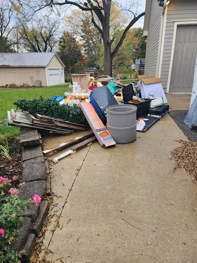 Dumpster being loaded with debris for Estate Cleanout Dumpster Rental in East Alton